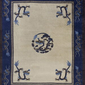 Beige rug featuring dark blue dragon designs in the center, corners, and wide navy border.