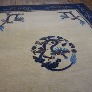 Cream rug with a blue dragon medallion and blue border featuring stylized dragons.