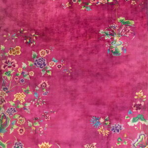 Deep magenta rug with multicolored floral borders and a distinct hanging vase motif on the right.