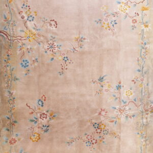 Shimmering beige rug featuring a delicate, low-pile botanical pattern of multicolored flowers, vines, and birds.