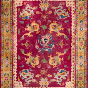Magenta rug with detailed gold and blue dragon motifs centered inside a complex gold and floral border.
