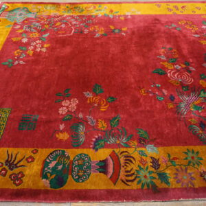 High pile magenta rug featuring complex multicolored botanical patterns and symbols within a gold border on wood flooring.