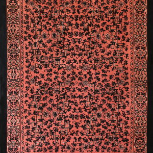 High-contrast rug featuring black scrolling floral and geometric designs on a dense coral field.