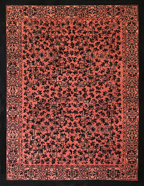 High-contrast rug featuring black scrolling floral and geometric designs on a dense coral field.
