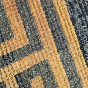 Three sections of rugs show textured yellow and gray geometric patterns transitioning to a soft black pile.