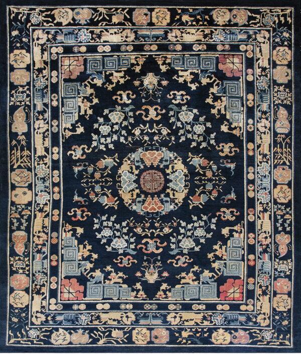 Detailed traditional rug with a navy blue field and complex borders featuring tan, rust, and light blue motifs.