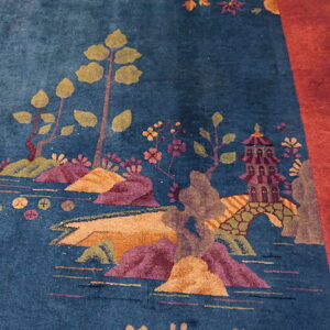 High-pile blue rug featuring a detailed landscape pattern with a purple pagoda and a wide red border.