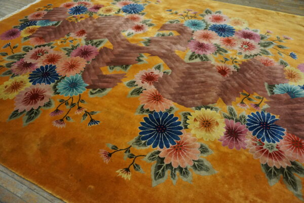 Golden yellow high-pile rug displaying carved multicolored floral clusters and a large reddish-brown abstract motif.