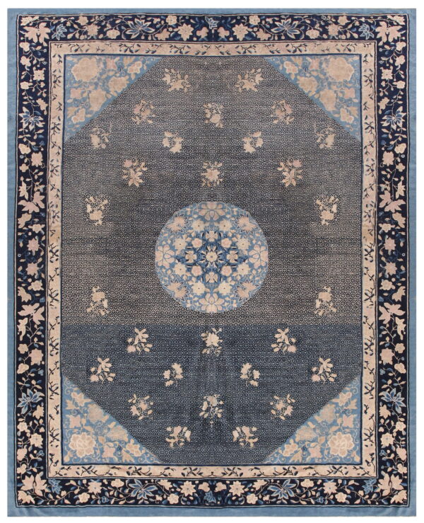 Traditional dark blue rug with beige floral details, a central medallion, and layered light blue floral borders.
