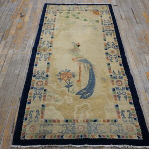 Beige runner rug with a colorful bird and tree pattern displayed on distressed wooden planks.