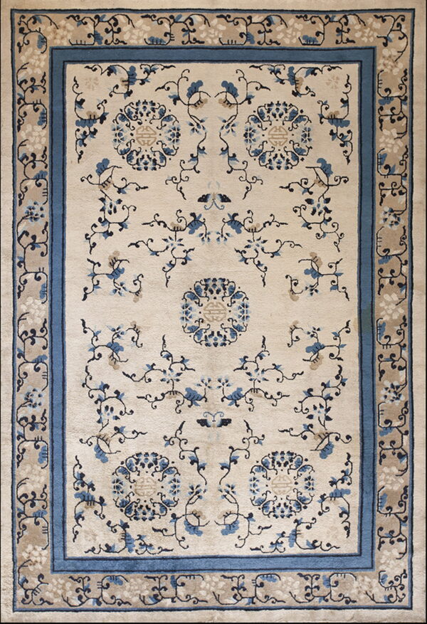 Beige rug with blue floral patterns and medallions, framed by a thick solid blue border.