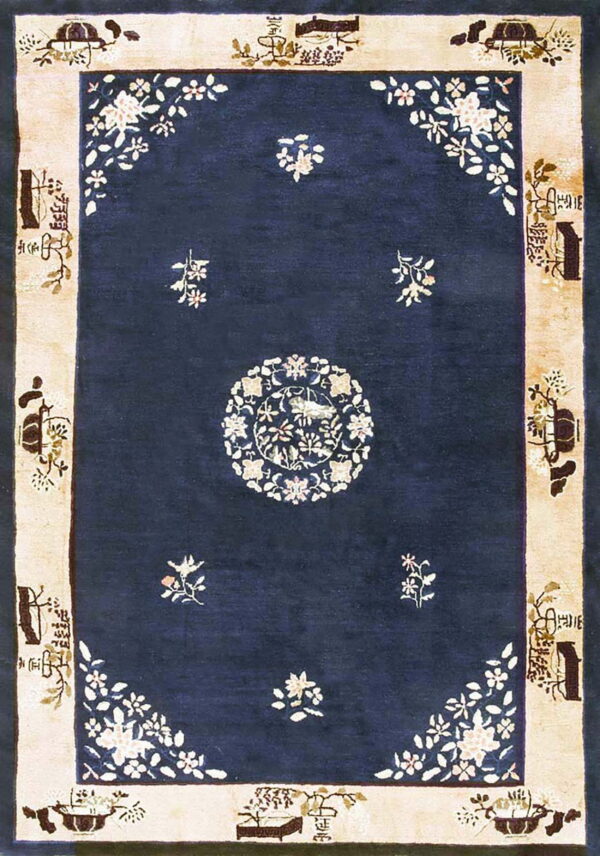 Dark blue rug with a large floral medallion, corner designs, and a light-colored pictorial border.
