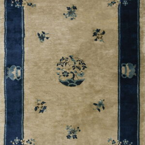 Beige rug with a navy border featuring light blue pagodas, floral sprays, and a central potted tree.