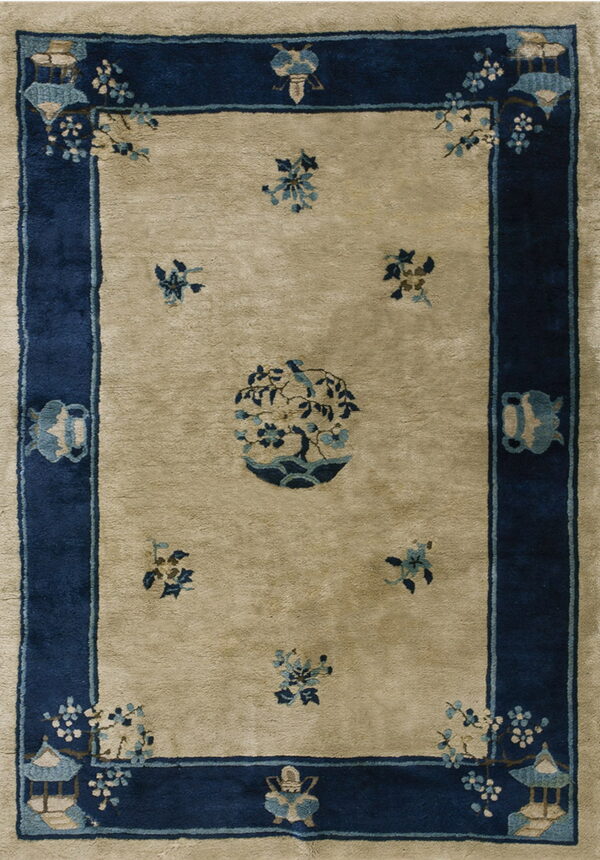 Beige rug with a navy border featuring light blue pagodas, floral sprays, and a central potted tree.