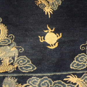 Navy cut-pile rug featuring large golden dragons, swirling blue-gray clouds, and a central round motif.