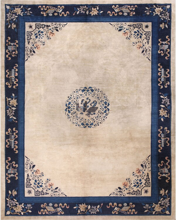 Beige rug featuring a central blue medallion and a thick navy border with floral and geometric patterns.