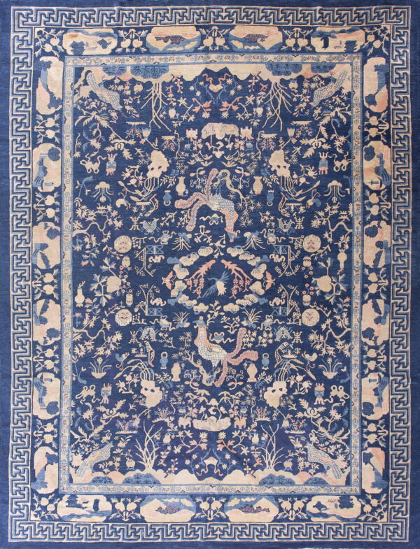 Navy blue rug with a dense traditional pattern in beige and pink, framed by geometric key borders.