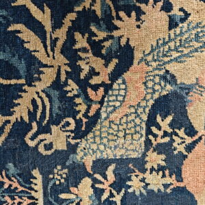 Complex woven pattern detail featuring deep blue, tan, light blue, and soft pink colors.