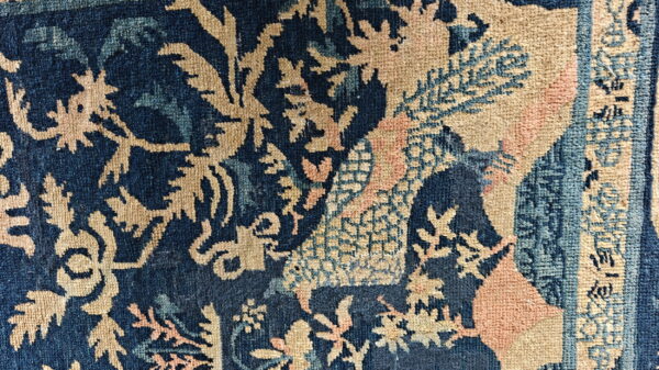 Complex woven pattern detail featuring deep blue, tan, light blue, and soft pink colors.