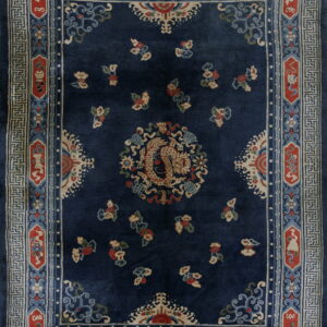 Dark blue rug with a beige dragon center, red details, and a geometric cream and blue fretwork border.