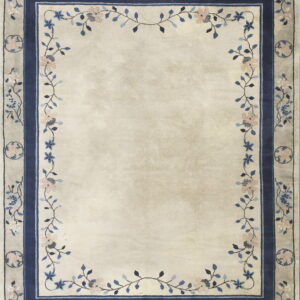 Ivory rug with a wide floral border featuring pink and blue flowers and vines around a solid center.