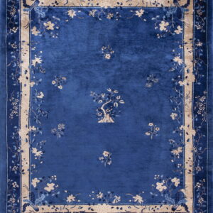 Deep blue medium-pile rug with beige floral sprigs and a thick patterned tan and blue border.