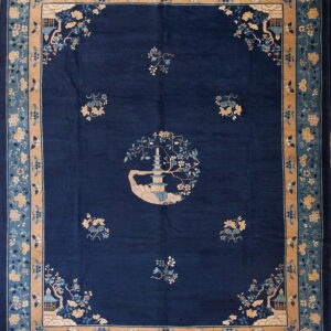 Deep blue rug featuring a central pagoda medallion and stylized light blue and tan floral borders.