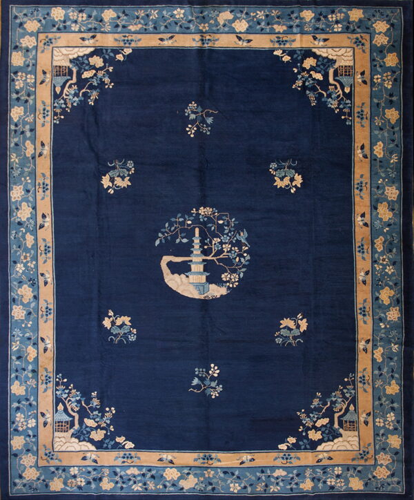 Deep blue rug featuring a central pagoda medallion and stylized light blue and tan floral borders.