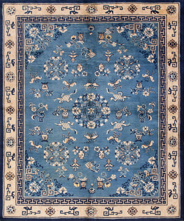 Blue field rug with detailed ivory and dark blue floral and medallion motifs inside a wide tan border.