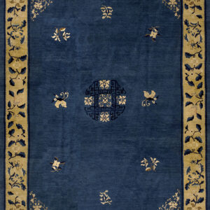 Deep blue rug with scattered tan motifs, a central geometric medallion, and a wide tan floral border.