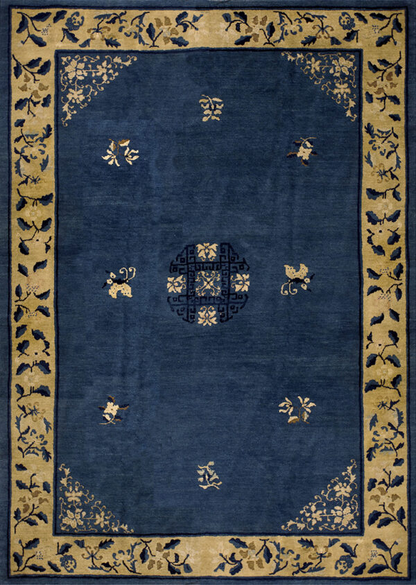 Wool hand knotted pile rectangle antique blue ivory beige cream white 1920s rug 1 Deep blue rug with scattered tan motifs, a central geometric medallion, and a wide tan floral border.