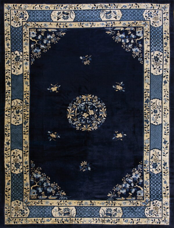 Plush navy rug with a central medallion and complex tan and blue floral borders.