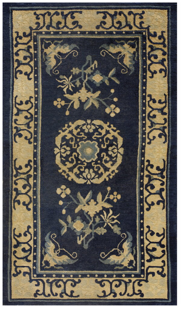 Ornate navy blue rug with beige floral patterns and a wide scroll-patterned border.
