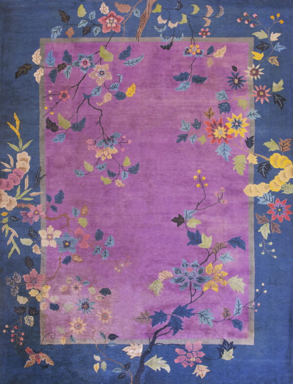 Purple rug with a blue border displays multicolored florals and vines trailing across the edges.