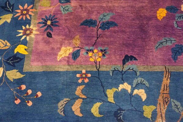 A plush rug detail shows multicolored floral vines across distinct purple and deep blue color fields.