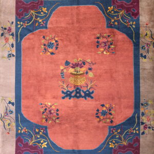 Salmon central field and blue spandrels surrounded by a taupe border detailed with multicolored floral sprays.