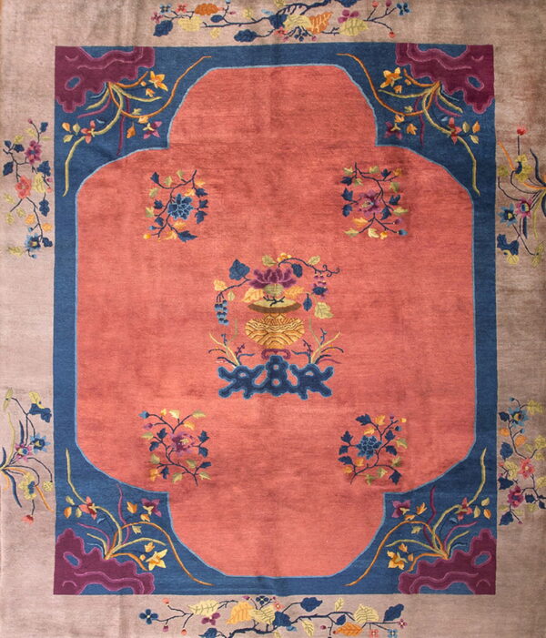 Salmon central field and blue spandrels surrounded by a taupe border detailed with multicolored floral sprays.