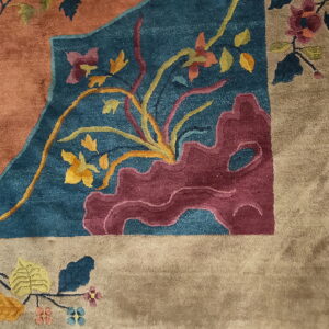 Plush rug detail featuring an ornate pattern in rust, teal blue, yellow, and tan colors.