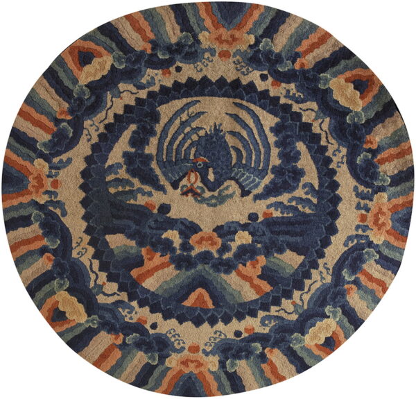 Round rug with a detailed central blue mythological creature pattern on a beige ground, accented with rust and green.