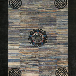 Low-pile rug with variegated horizontal stripes, a dark border, corner knot motifs, and a colorful central medallion.