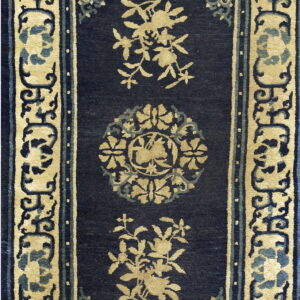 Rectangular navy blue rug with stylized beige floral motifs and a complex scrolling border design.