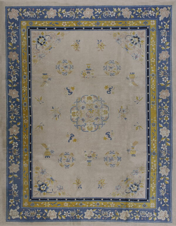 Beige rug with a wide blue floral border and contrasting yellow guard stripes around scattered traditional designs.