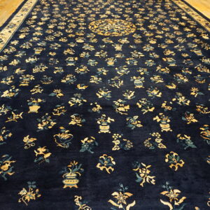 Long navy rug featuring dense yellow and teal botanical motifs on golden hardwood flooring.