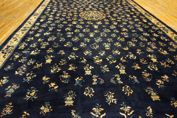 Long navy rug featuring dense yellow and teal botanical motifs on golden hardwood flooring.