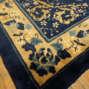 Antique blue rug with floral design.