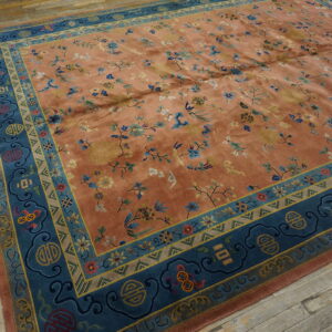 Terracotta and teal rug featuring an all-over floral pattern and symbolic borders on rustic wood floors.