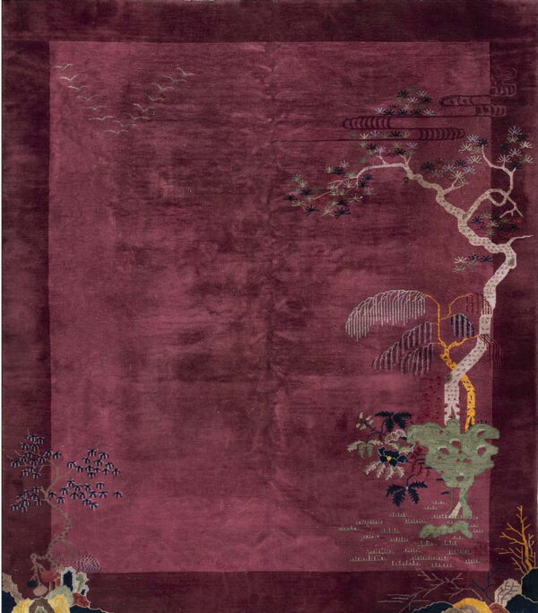 Deep-pile maroon rug featuring stylized corner motifs of light trees, foliage, clouds, and flying birds.