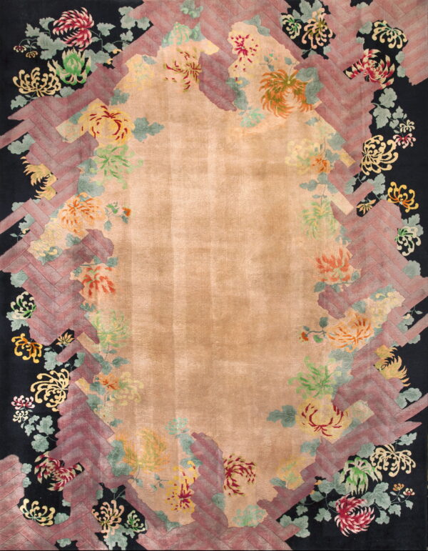 Tan central field rug featuring a black border covered in vibrant flowers and a decorative maroon zigzag frame.