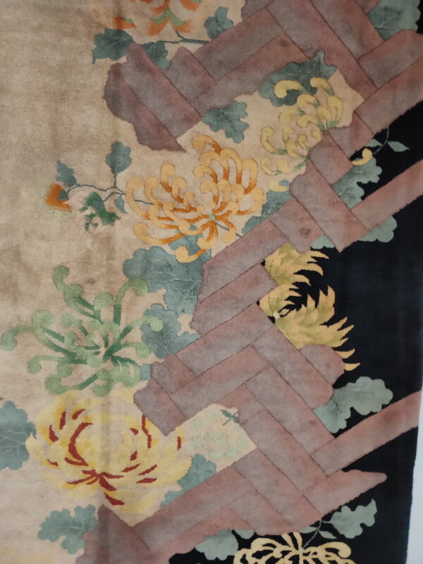 Textured rug with yellow flowers, green leaves, and a diagonal rose-colored geometric weave pattern.