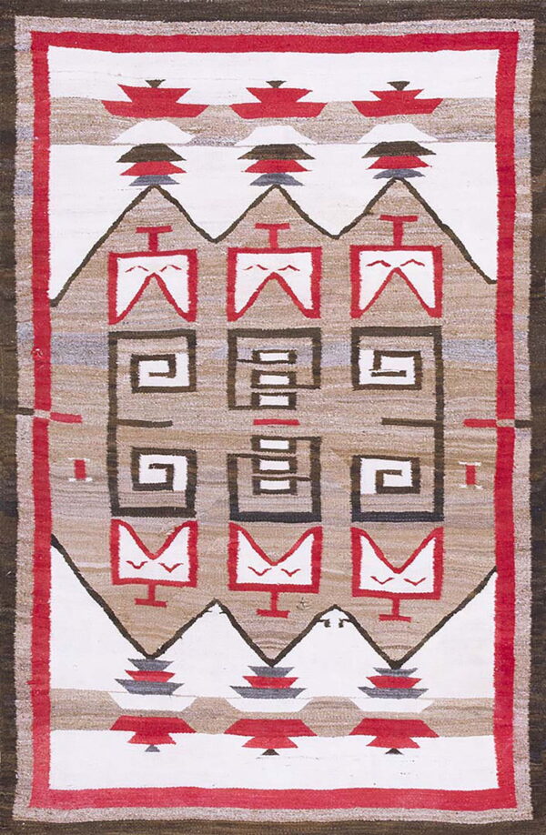 Geometric flatweave rug in white, red, tan, and brown with stacked motifs and spiral patterns.